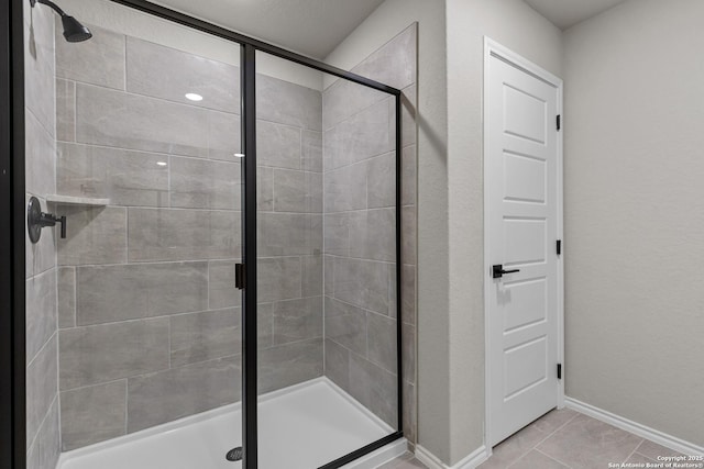 bathroom featuring a shower with shower door and tile patterned floors