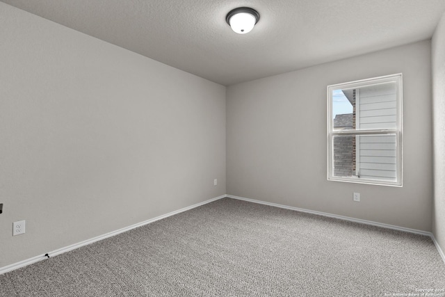 unfurnished room with a textured ceiling and carpet flooring