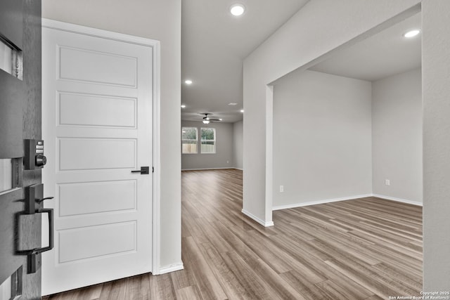 foyer entrance featuring ceiling fan and light wood-type flooring