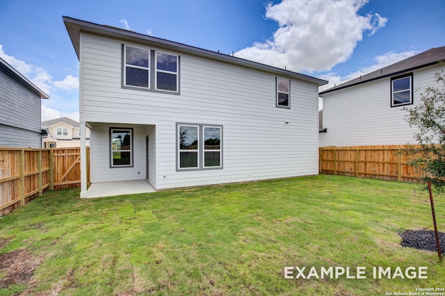 back of house with a patio area and a yard