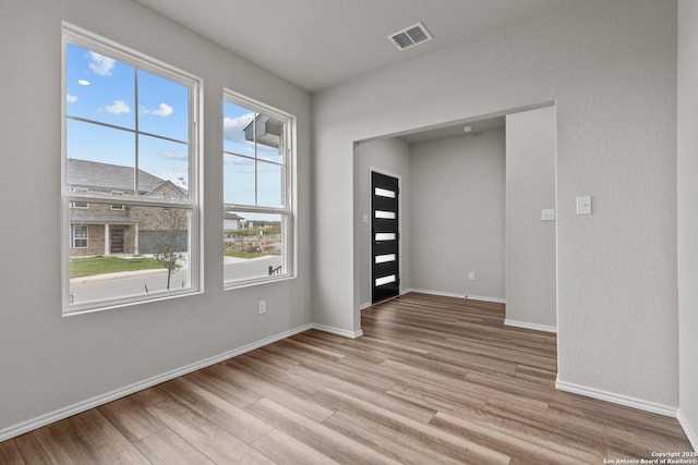 unfurnished room featuring light hardwood / wood-style floors