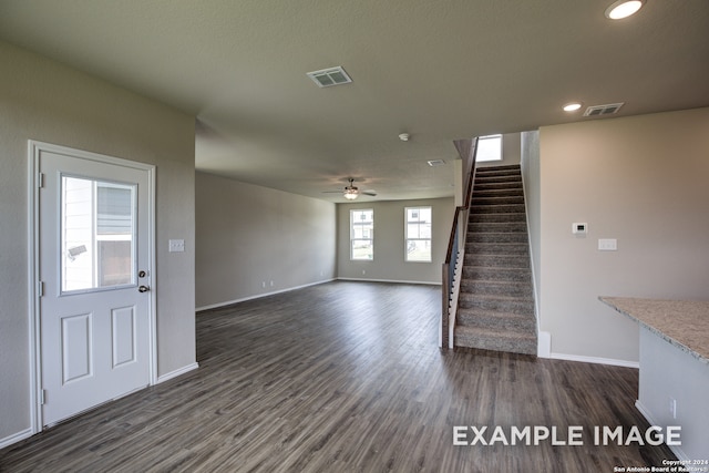 interior space featuring ceiling fan and dark wood-type flooring