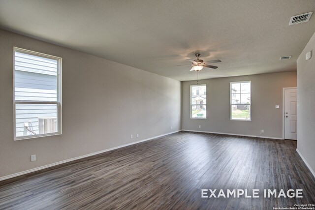 spare room featuring a textured ceiling, dark hardwood / wood-style flooring, and ceiling fan