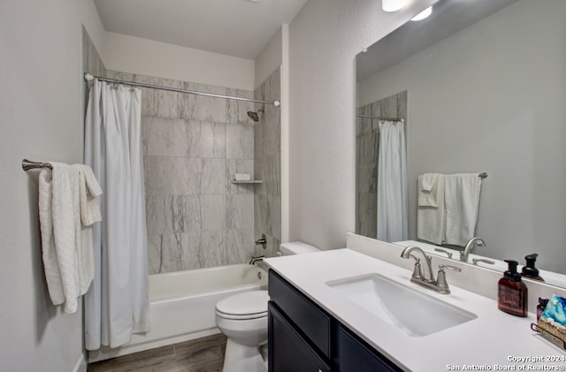 full bathroom with shower / bath combo with shower curtain, wood-type flooring, vanity, and toilet