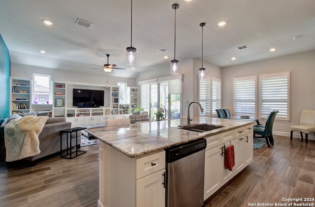 kitchen featuring a kitchen island with sink, sink, white cabinetry, stainless steel dishwasher, and hardwood / wood-style flooring