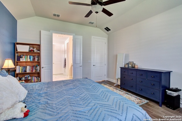 bedroom featuring ceiling fan, wood-type flooring, and vaulted ceiling