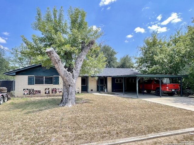 single story home featuring a front yard and a carport