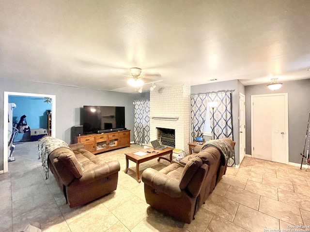 living room with ceiling fan and a fireplace