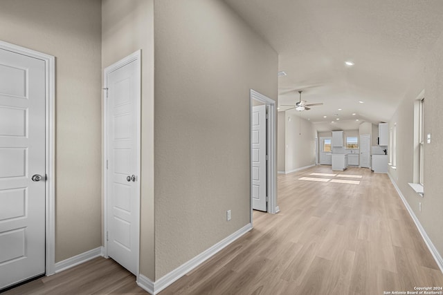 hallway with lofted ceiling