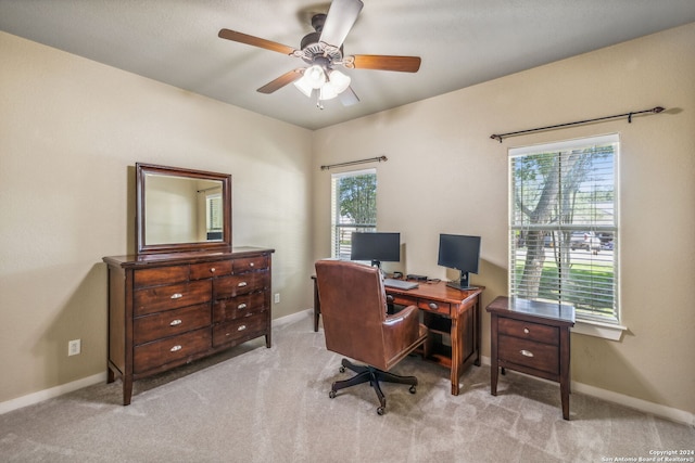 office space featuring light carpet and ceiling fan