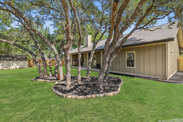 rear view of property with a lawn