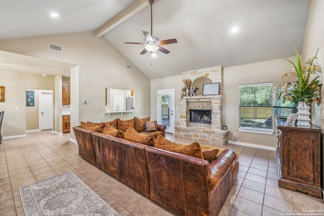 tiled living room with ceiling fan, a fireplace, high vaulted ceiling, and beam ceiling