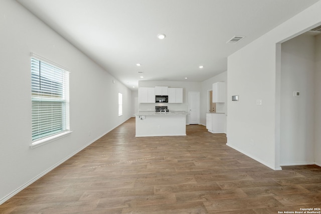 unfurnished living room featuring hardwood / wood-style floors