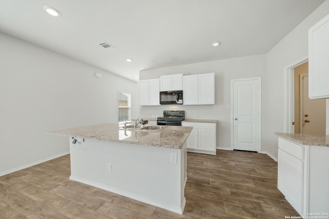 kitchen featuring white cabinets, a center island with sink, sink, range with electric cooktop, and light hardwood / wood-style flooring