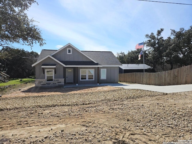 view of front of property with fence and board and batten siding