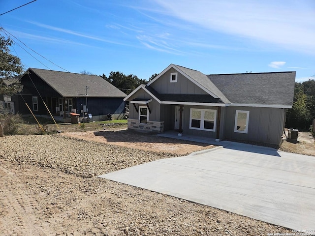 view of front of house featuring roof with shingles and board and batten siding