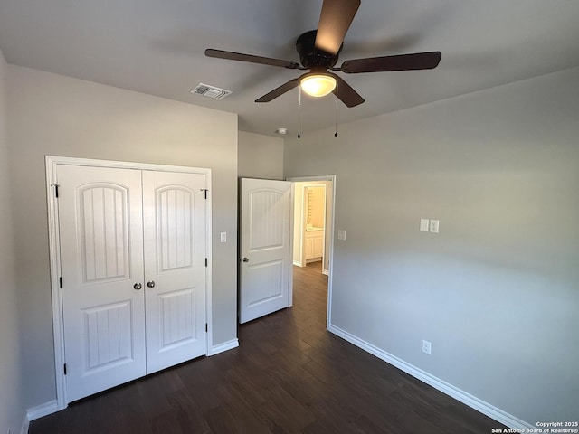 unfurnished bedroom with visible vents, baseboards, a ceiling fan, dark wood-style floors, and a closet