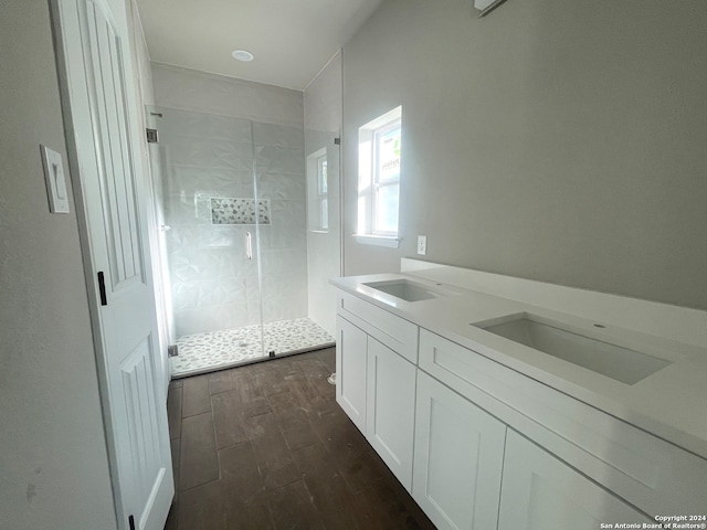 bathroom featuring wood-type flooring, a shower with door, and vanity