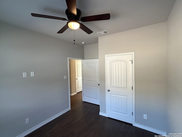 unfurnished bedroom with visible vents, baseboards, ceiling fan, and dark wood-type flooring