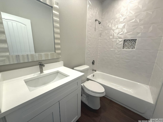 bathroom with toilet, vanity, wood finished floors, and shower / bathing tub combination