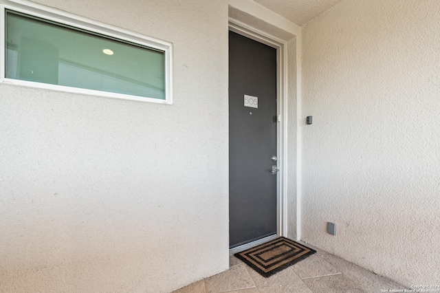 property entrance with stucco siding