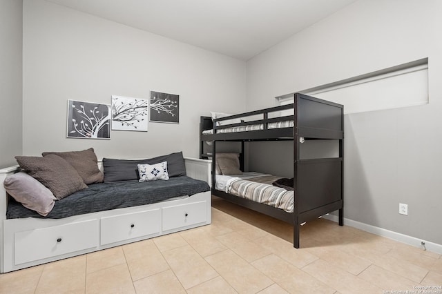 bedroom featuring baseboards and light tile patterned floors