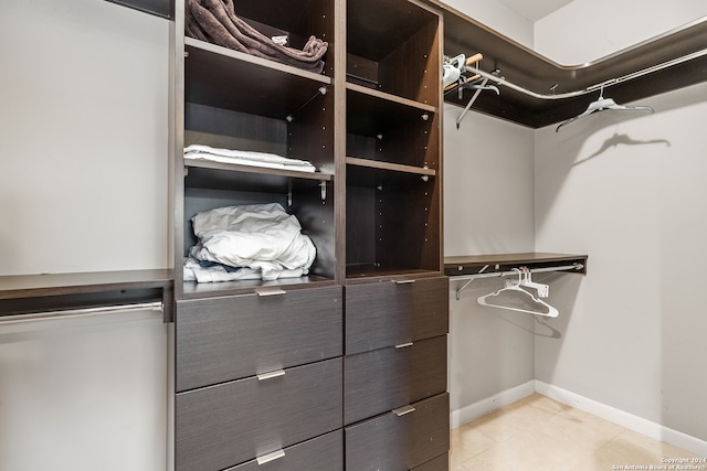 walk in closet featuring light tile patterned flooring