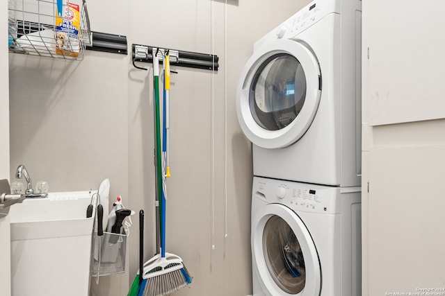 washroom featuring stacked washer and dryer