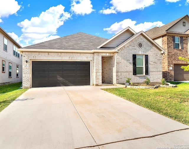 view of front facade with a front lawn and a garage