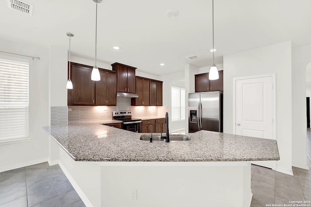 kitchen featuring pendant lighting, decorative backsplash, appliances with stainless steel finishes, sink, and kitchen peninsula