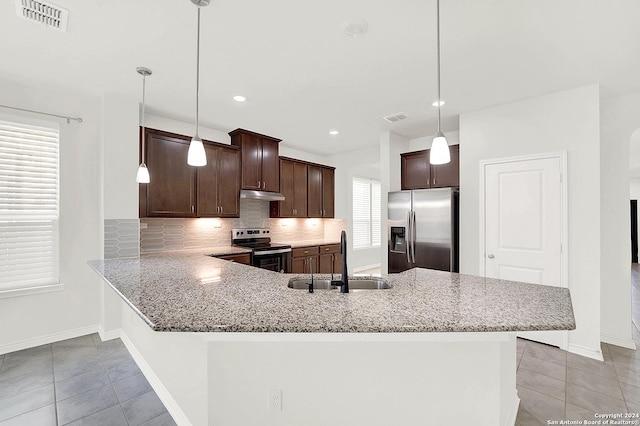 kitchen featuring appliances with stainless steel finishes, sink, pendant lighting, kitchen peninsula, and decorative backsplash