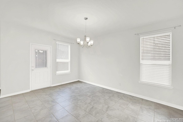 empty room with a notable chandelier