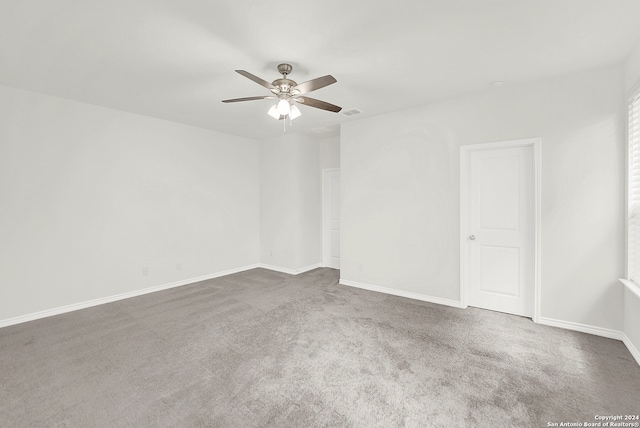 spare room featuring ceiling fan and carpet