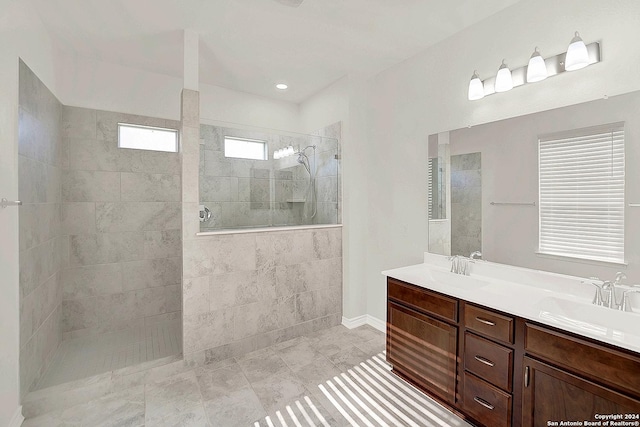 bathroom featuring vanity and a tile shower