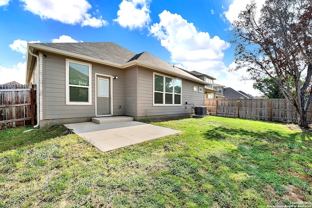 rear view of property featuring central AC, a lawn, and a patio area