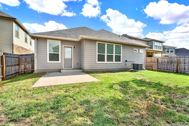 rear view of property featuring a patio area, a yard, and central air condition unit