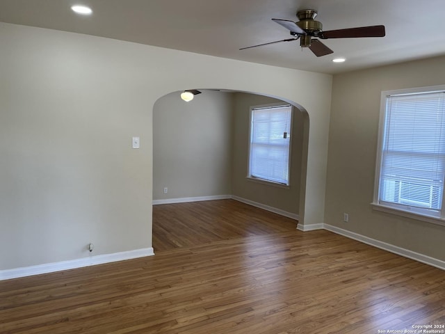 empty room featuring hardwood / wood-style flooring and ceiling fan