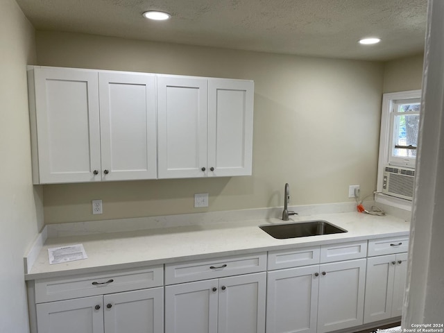 kitchen featuring sink and white cabinets