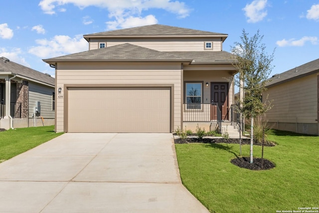 view of front facade with a garage and a front lawn