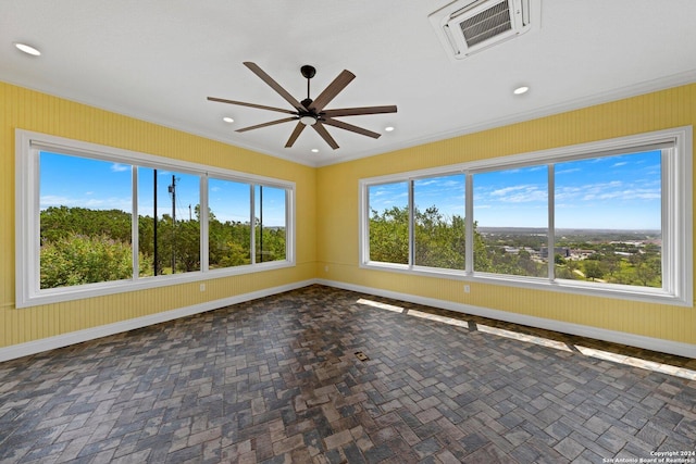 spare room with brick floor, visible vents, and baseboards