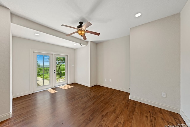 spare room featuring ceiling fan, french doors, and dark hardwood / wood-style floors