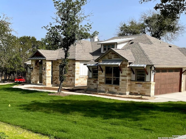 view of front of property featuring a garage and a front lawn