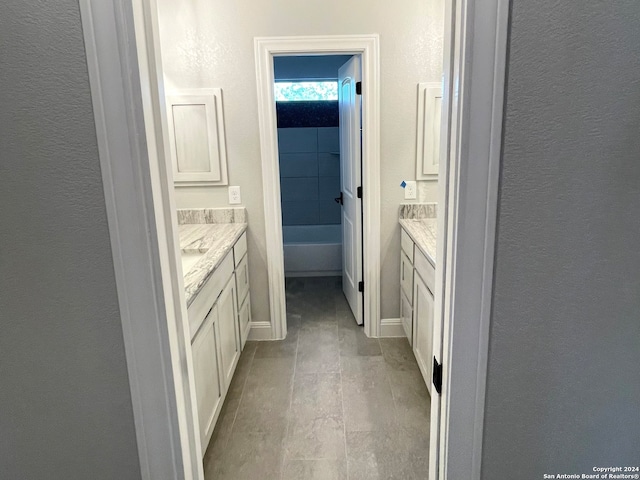 bathroom with vanity, a bathing tub, and hardwood / wood-style floors