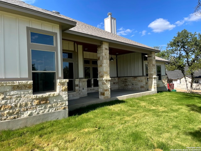 back of property with a lawn and a patio area