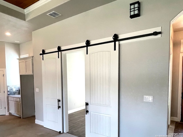 unfurnished bedroom featuring ornamental molding, hardwood / wood-style floors, and connected bathroom