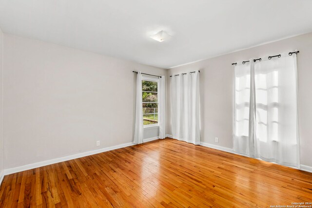 unfurnished room with light wood-type flooring