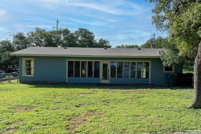 back of property featuring a yard