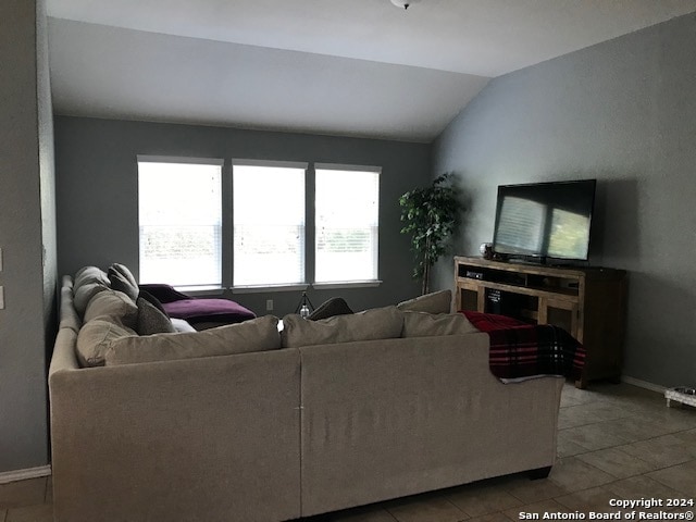 tiled living room with lofted ceiling