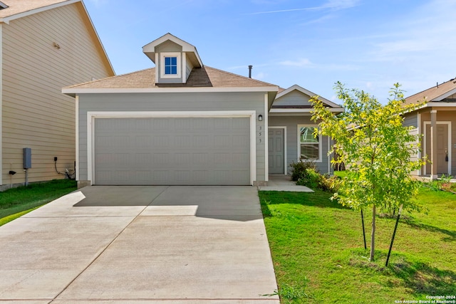 view of front of house with a garage and a front lawn