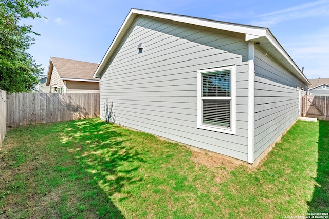 view of home's exterior featuring a yard and a fenced backyard